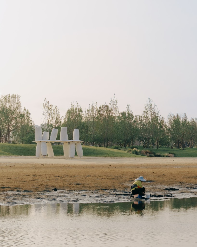 white stainless-steel cylinders form coral-like swing installation on chinese coast - 1