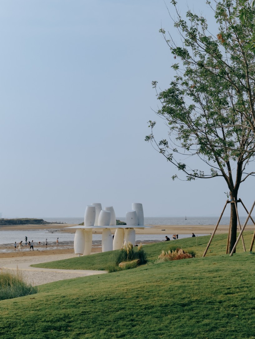 white stainless-steel cylinders form coral-like swing installation on chinese coast - 2