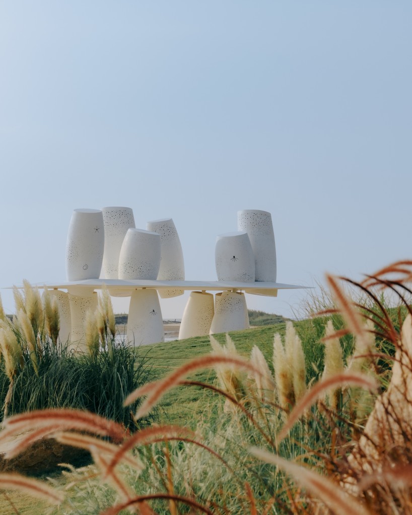 white stainless-steel cylinders form coral-like swing installation on chinese coast - 3