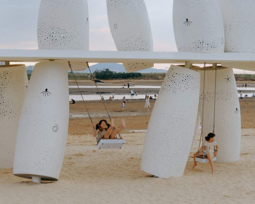 white stainless-steel cylinders form coral-like swing installation on chinese coast - 5