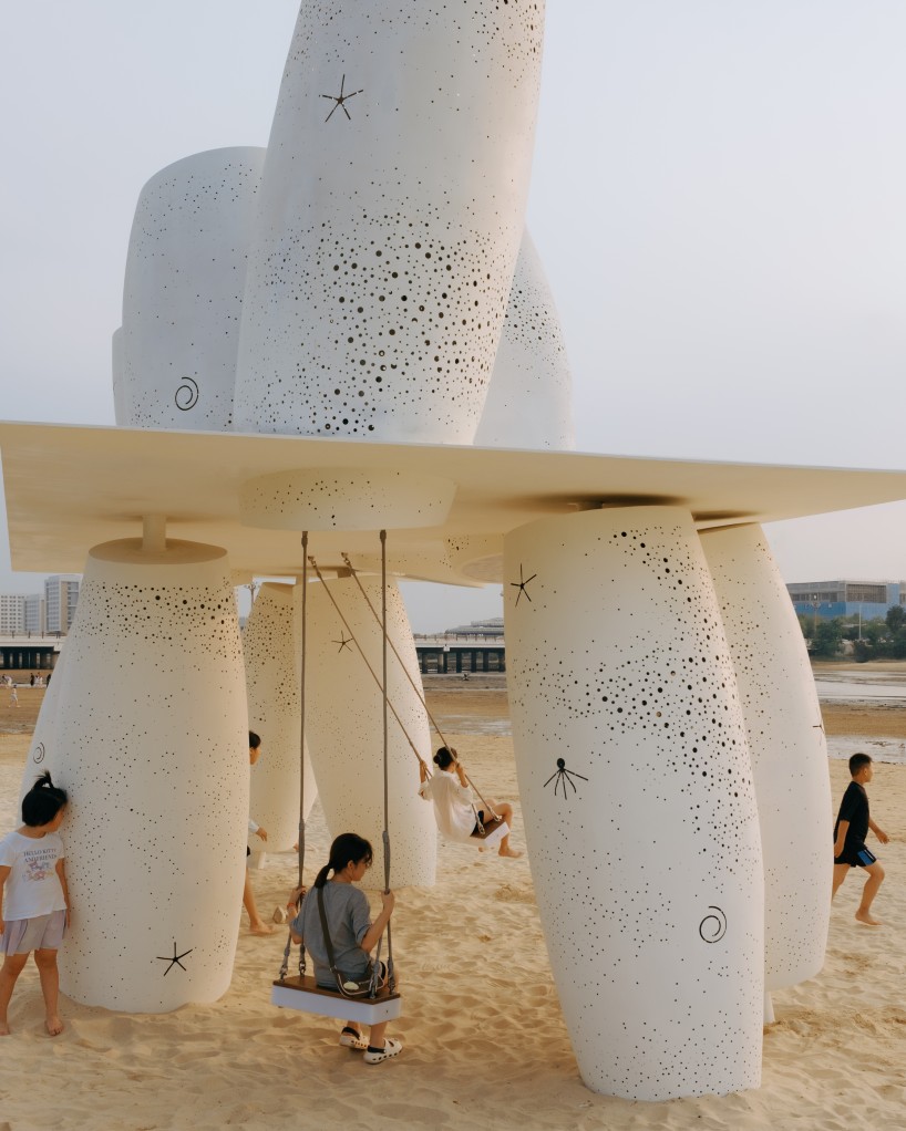 white stainless-steel cylinders form coral-like swing installation on chinese coast - 7