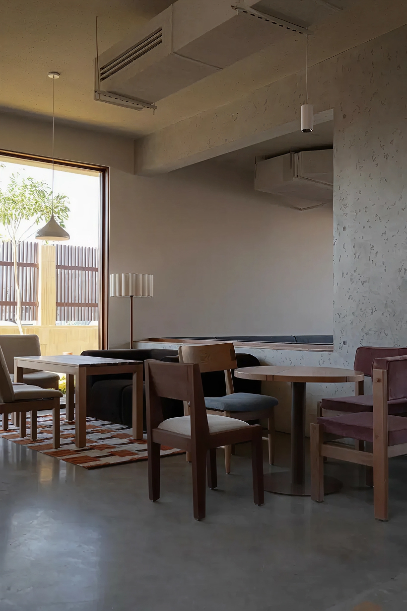 open planted courtyard organizes a caf&eacute; carved directly into rock in saudi arabia