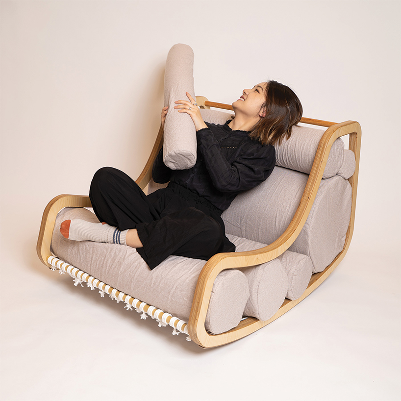 a series of movable cylindrical cushions reposition to form modular column chair - 6