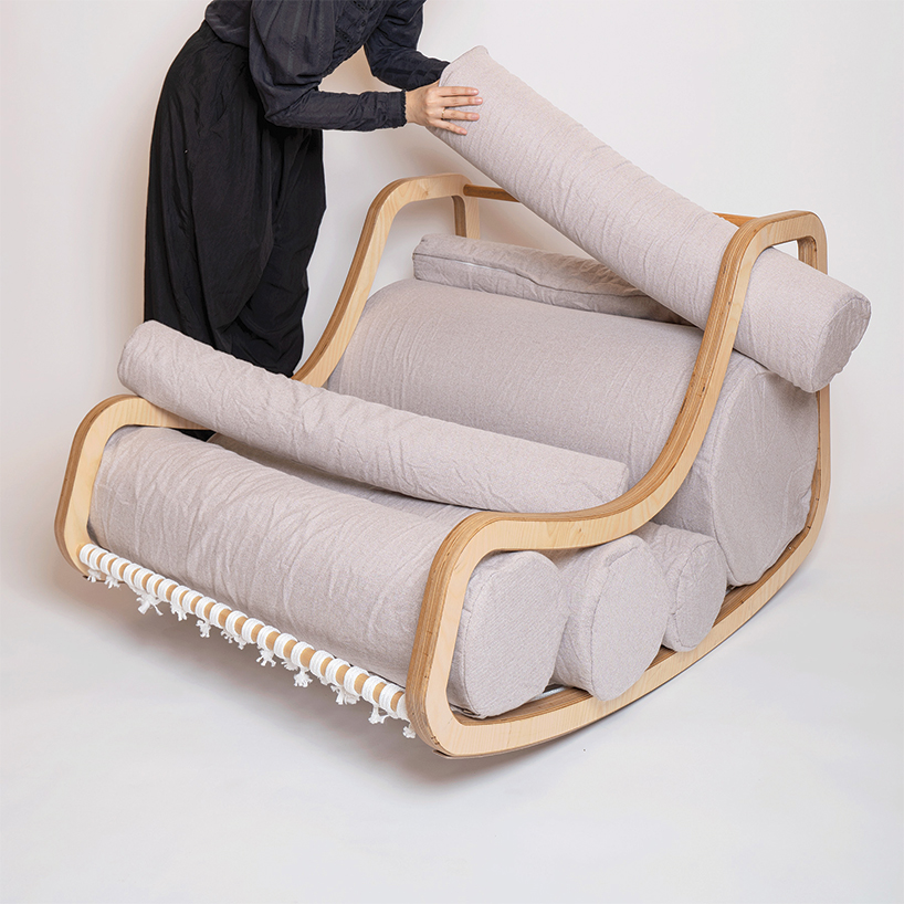 a series of movable cylindrical cushions reposition to form modular column chair - 2