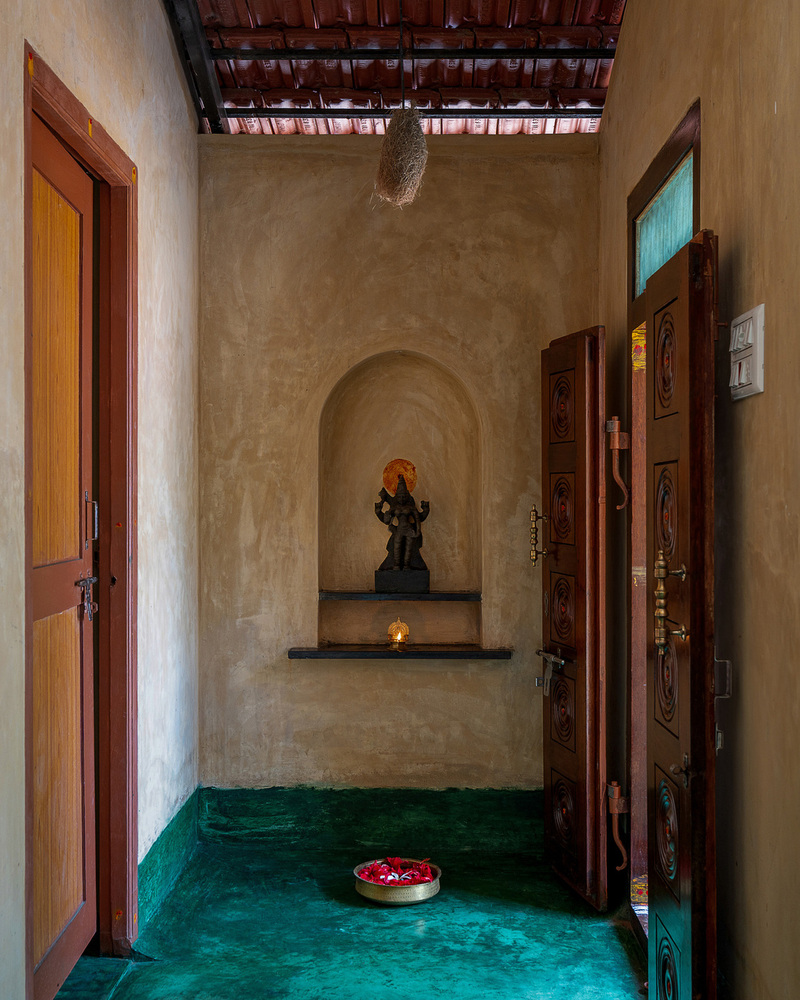 thousands of reclaimed bricks shape rural residence amid agricultural fields in india