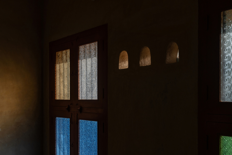 thousands of reclaimed bricks shape rural residence amid agricultural fields in india