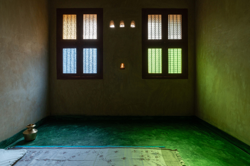 thousands of reclaimed bricks shape rural residence amid agricultural fields in india