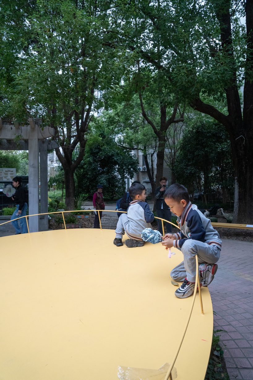 studio RE+N turns abandoned planter into floating yellow stage in shanghai neighborhood - 7