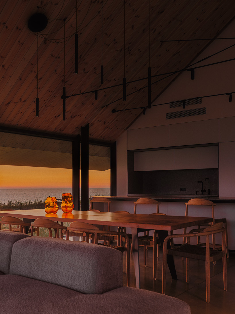 grass-covered seaside family home repurposes abandoned soviet military bunkers in latvia - 11