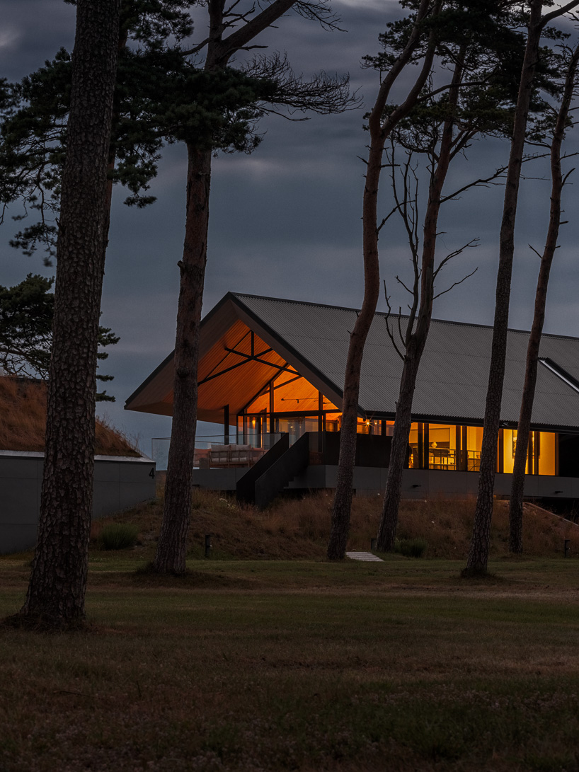 grass-covered seaside family home repurposes abandoned soviet military bunkers in latvia - 12