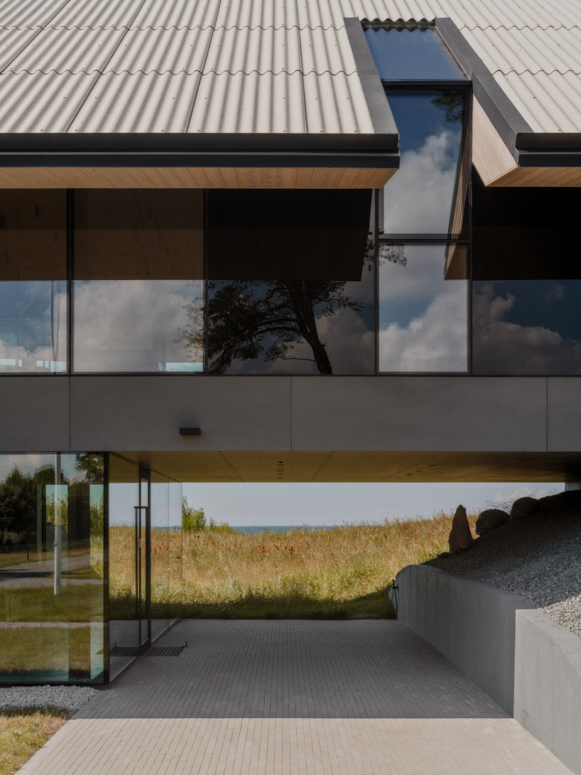 grass-covered seaside family home repurposes abandoned soviet military bunkers in latvia - 5