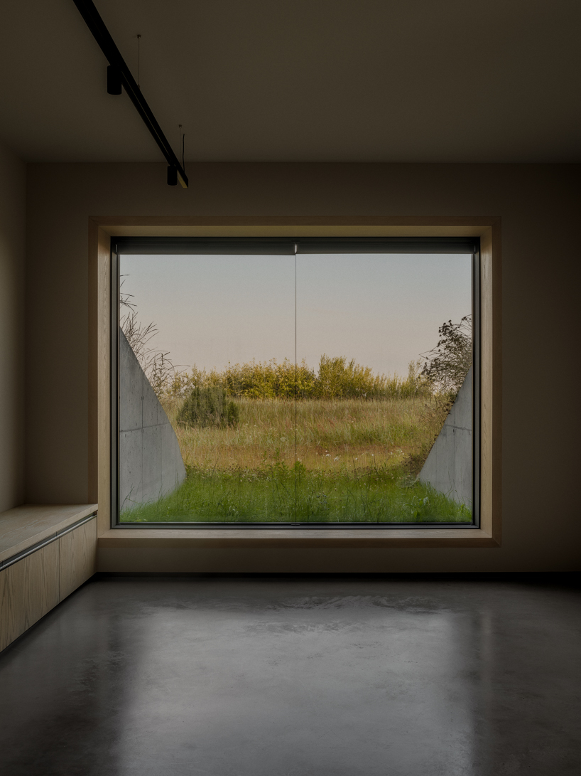 grass-covered seaside family home repurposes abandoned soviet military bunkers in latvia - 6