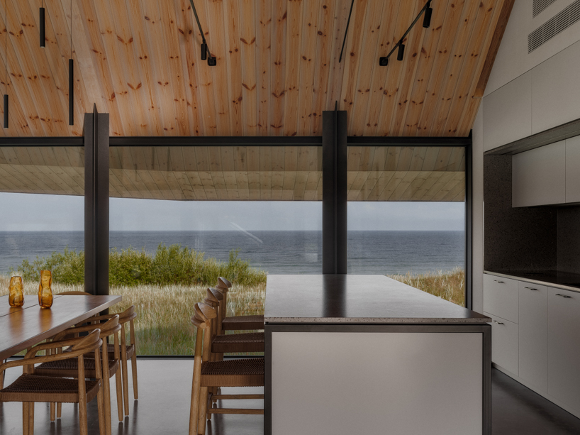 grass-covered seaside family home repurposes abandoned soviet military bunkers in latvia - 7