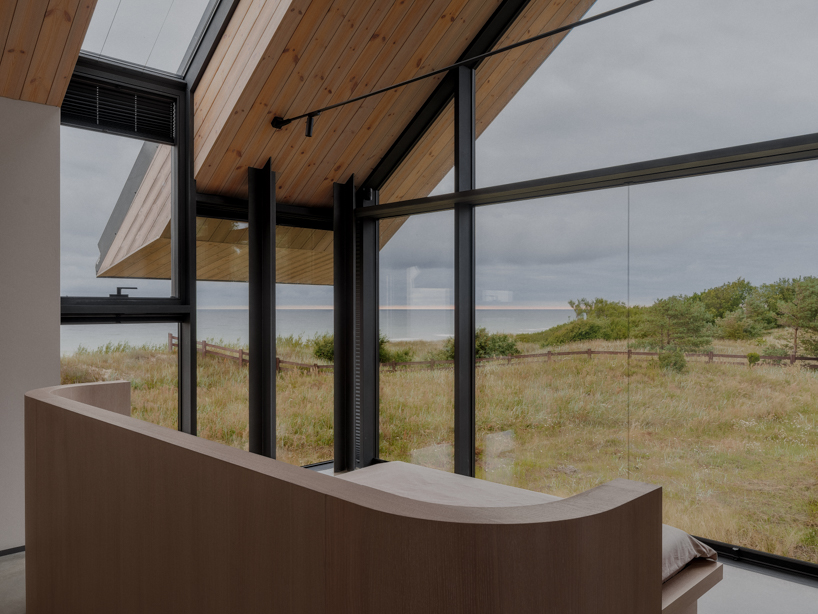 grass-covered seaside family home repurposes abandoned soviet military bunkers in latvia - 9