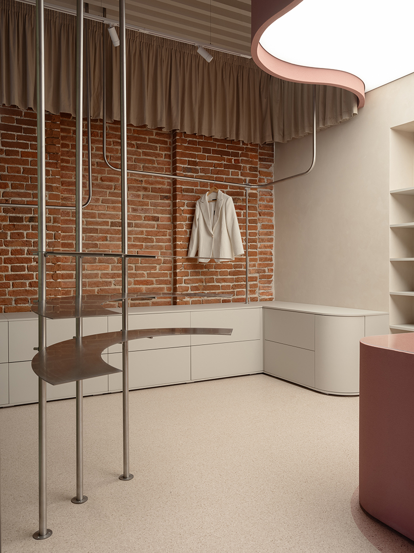 curved pink interiors animate hybrid retail-caf&eacute; space within brick shell - 9