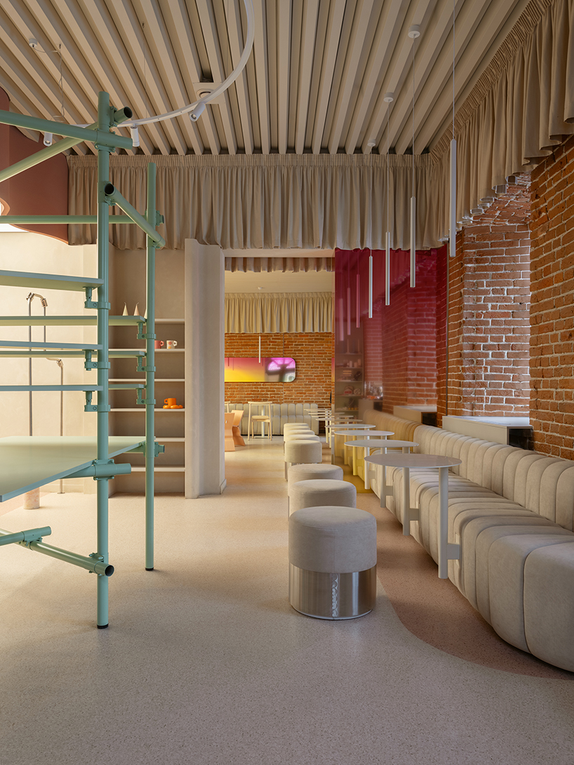 curved pink interiors animate hybrid retail-caf&eacute; space within brick shell - 11