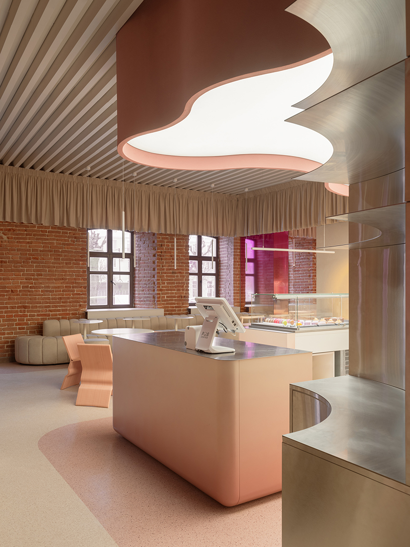 curved pink interiors animate hybrid retail-caf&eacute; space within brick shell - 7