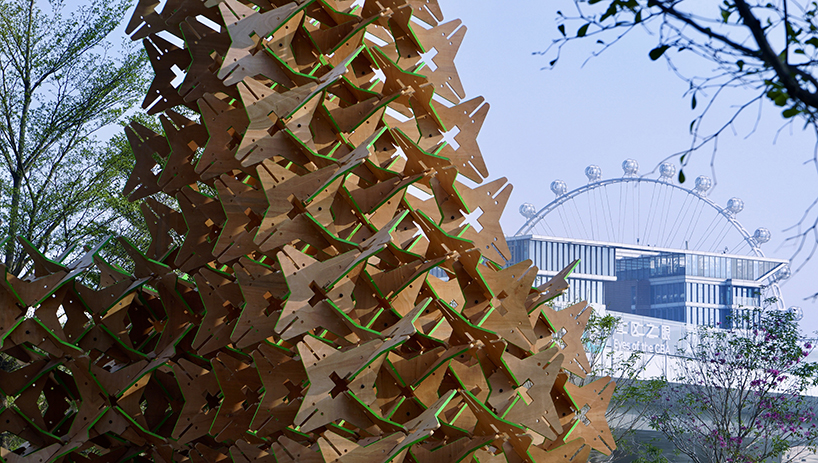 hundreds of interlocking star modules build a porous timber installation - 7