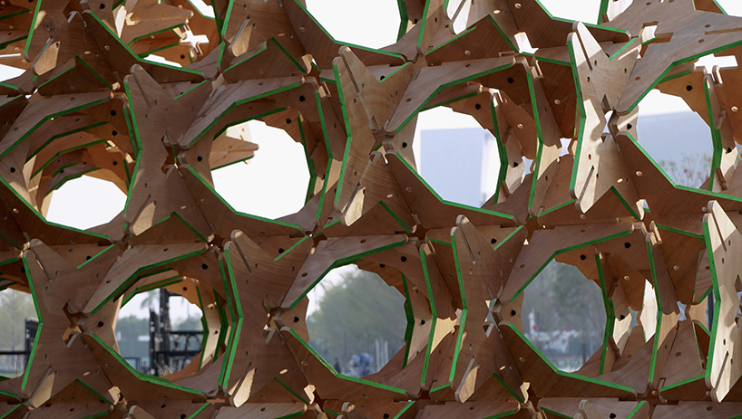 hundreds of interlocking star modules build a porous timber installation - 9