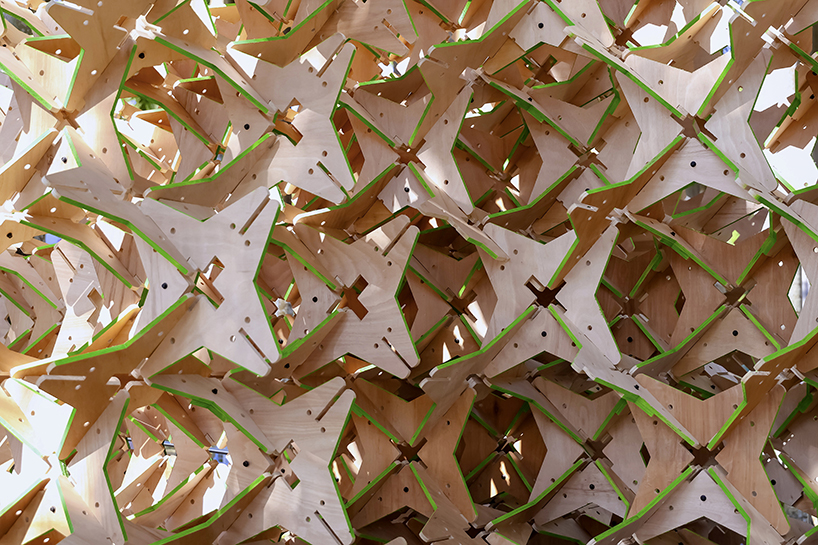 hundreds of interlocking star modules build a porous timber installation - 10
