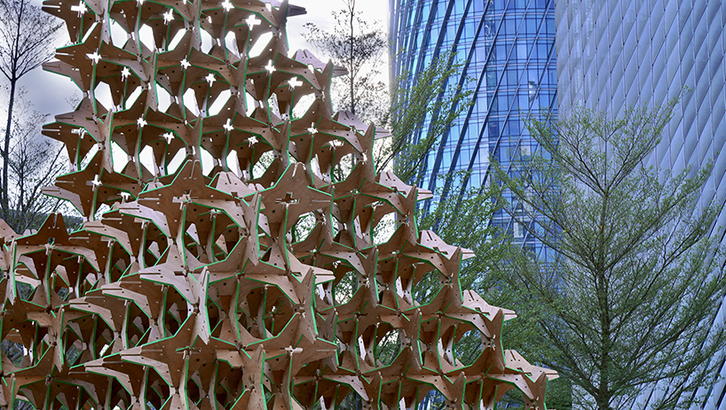 hundreds of interlocking star modules build a porous timber installation - 6