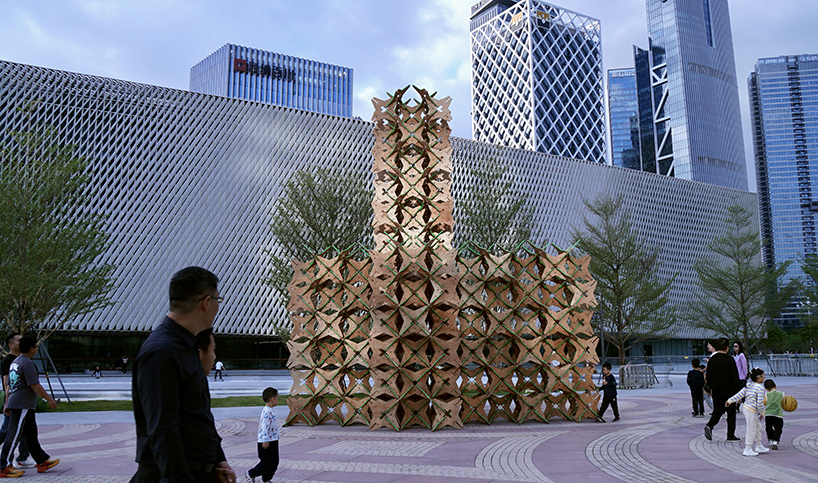 hundreds of interlocking star modules build a porous timber installation - 1