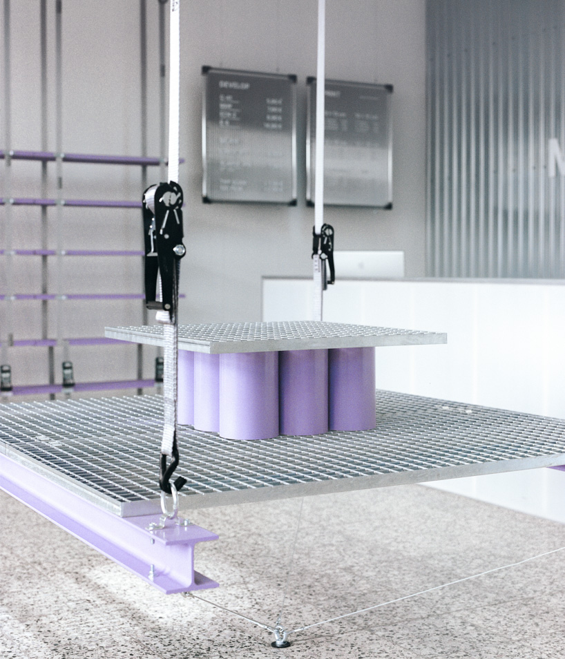 steel grates suspended from ratchet straps turn into furniture for bratislava photo lab - 8
