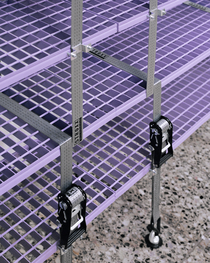steel grates suspended from ratchet straps turn into furniture for bratislava photo lab - 10