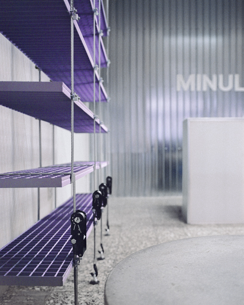 steel grates suspended from ratchet straps turn into furniture for bratislava photo lab - 9