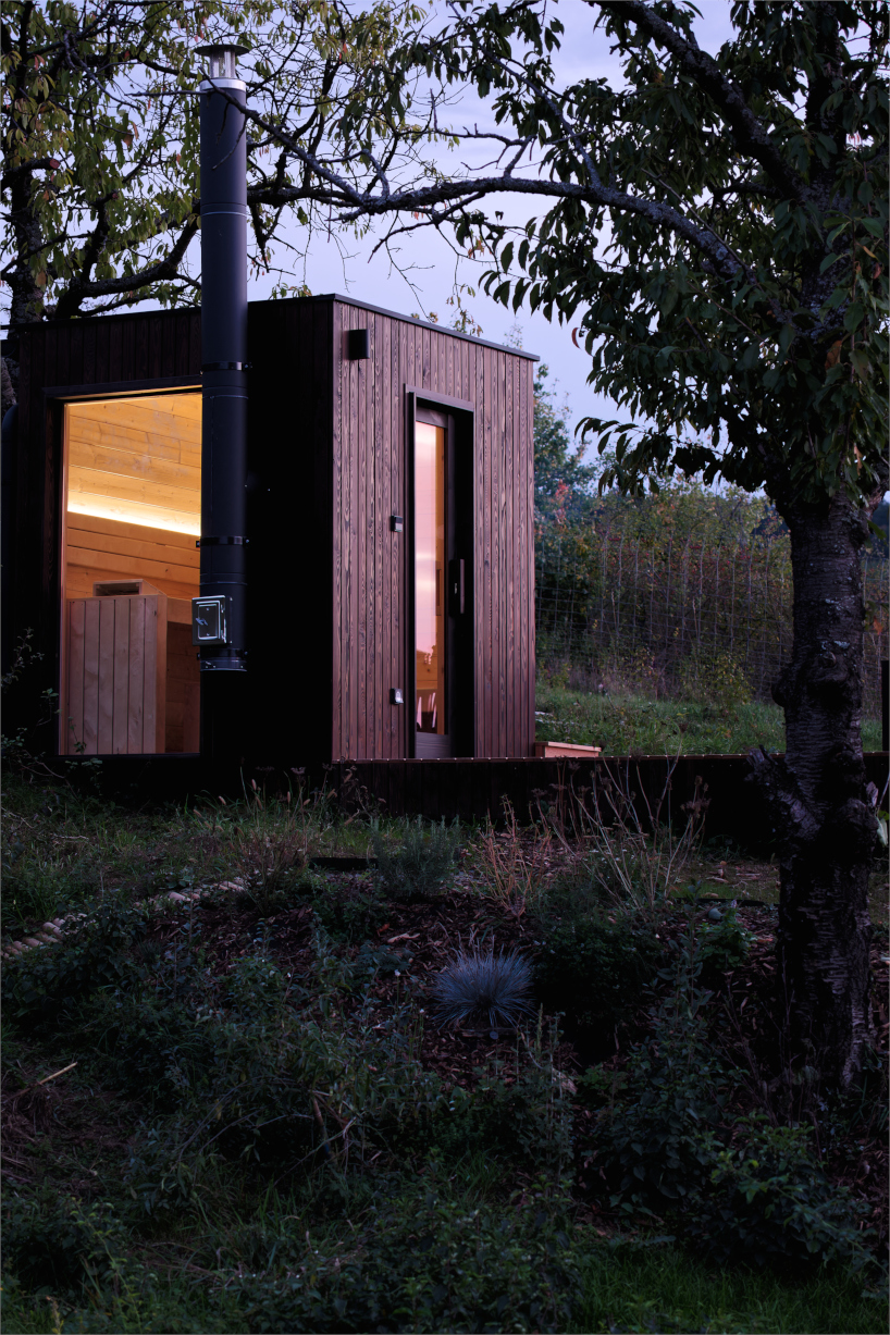 prefabricated timber micro-cabin extends living into the hungarian landscape - 9