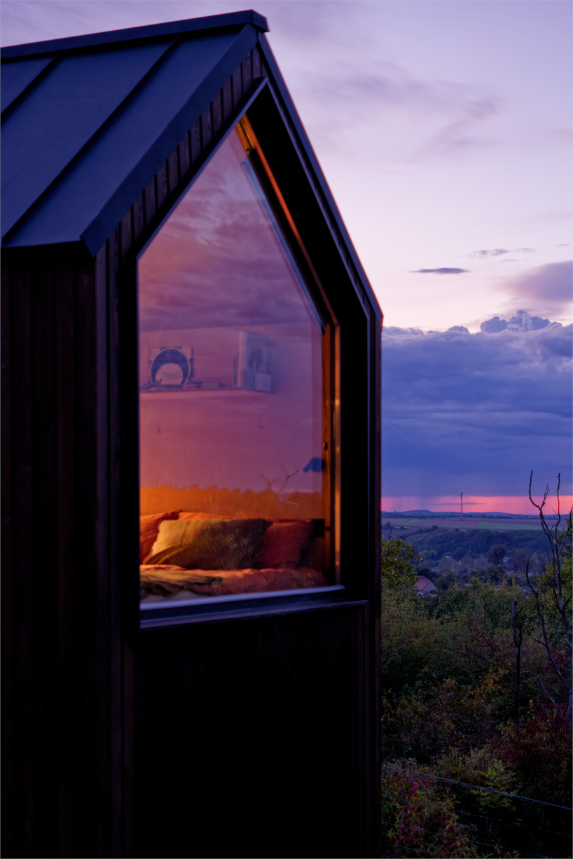 prefabricated timber micro-cabin extends living into the hungarian landscape - 10