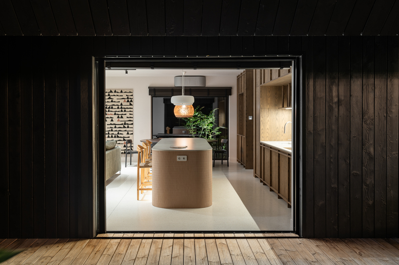 dark timber A&A house reinterprets traditional barn form within polish pine forest - 9