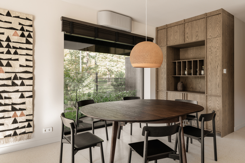 dark timber A&A house reinterprets traditional barn form within polish pine forest - 12