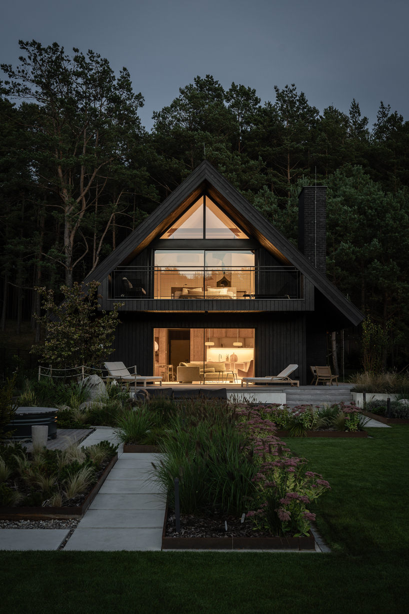 dark timber A&A house reinterprets traditional barn form within polish pine forest - 6