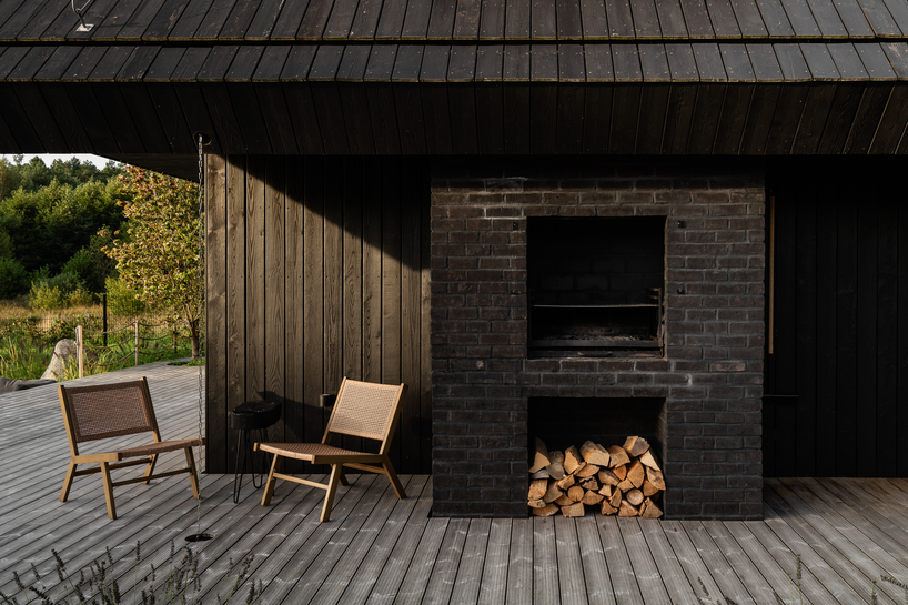 dark timber A&A house reinterprets traditional barn form within polish pine forest - 5