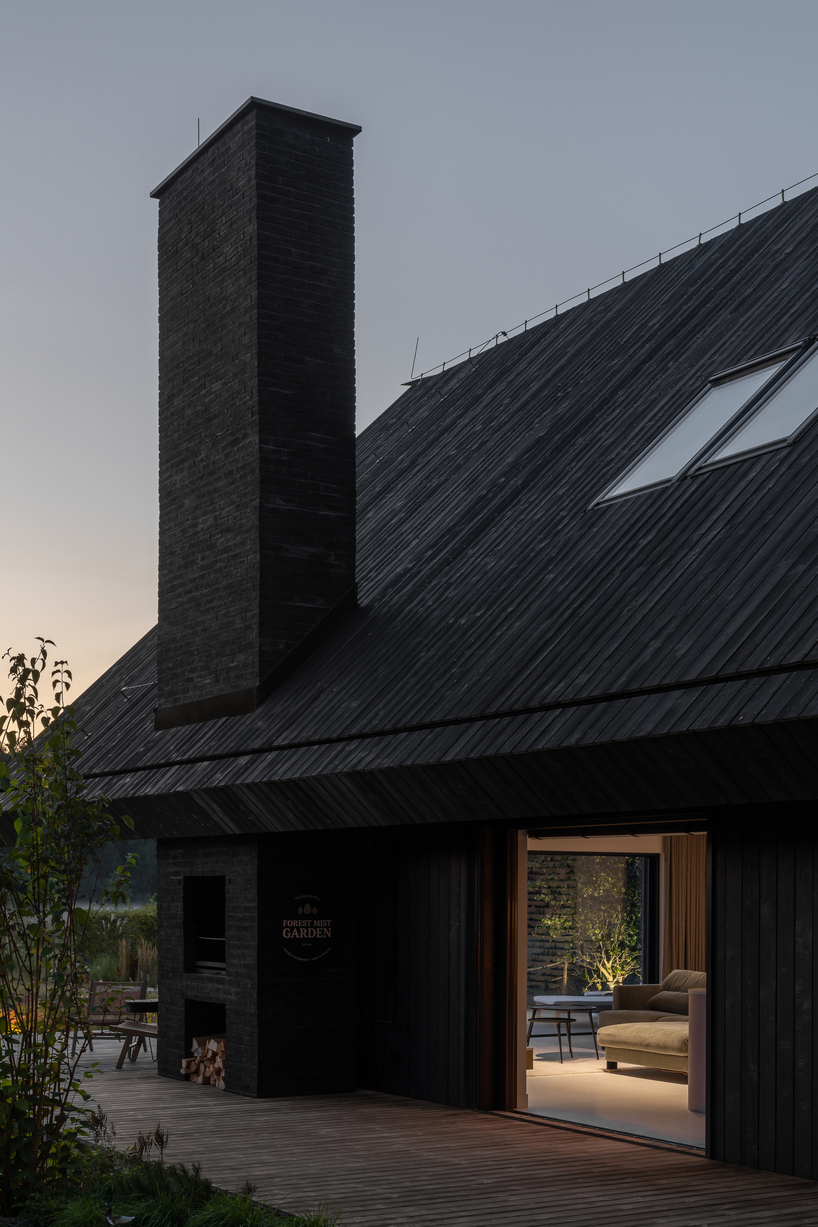 dark timber A&A house reinterprets traditional barn form within polish pine forest - 7