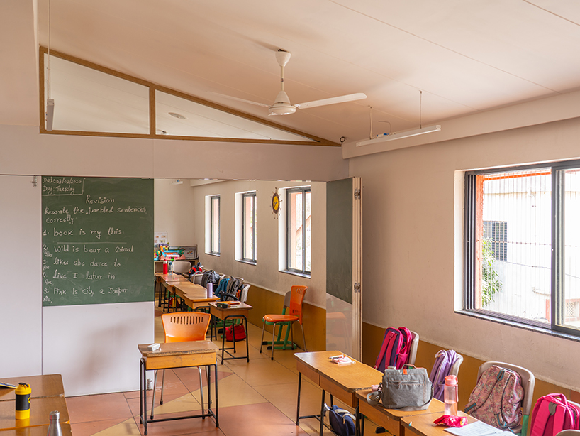 underused house reconfigures into child-centered bright red preschool in india - 7