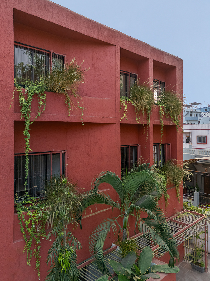 underused house reconfigures into child-centered bright red preschool in india - 5