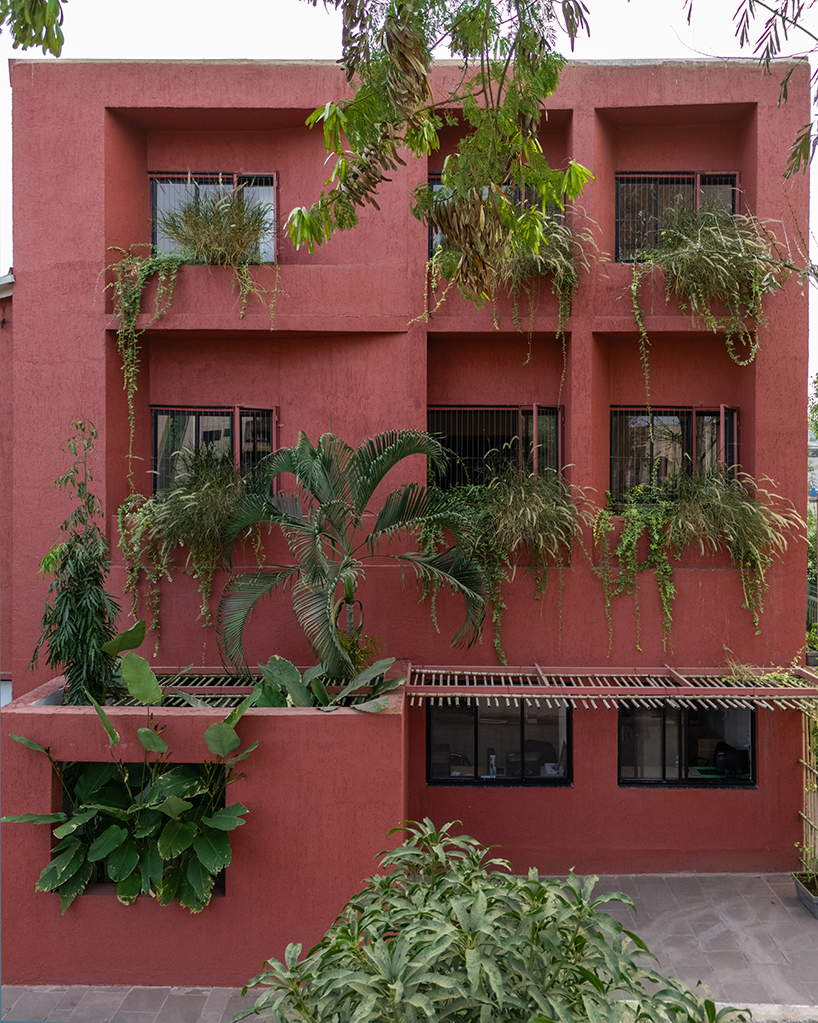 underused house reconfigures into child-centered bright red preschool in india - 6