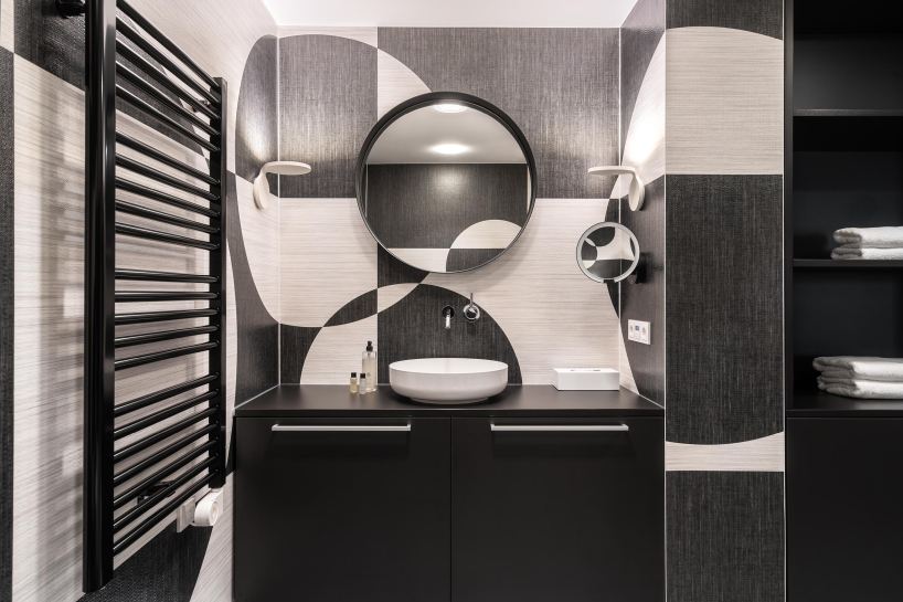 circle meets square in hotel suite interior defined by black-and-white wall compositions - 4