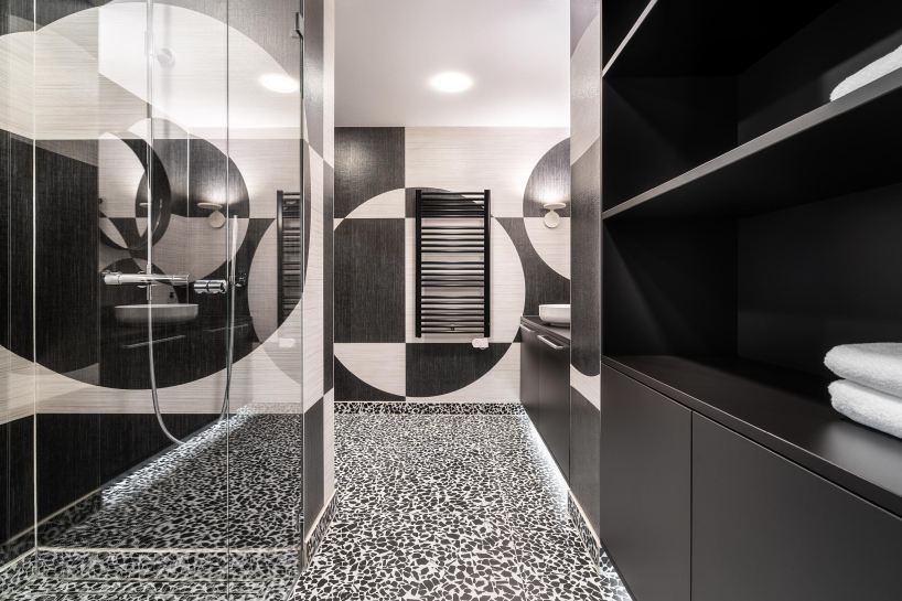 circle meets square in hotel suite interior defined by black-and-white wall compositions - 5