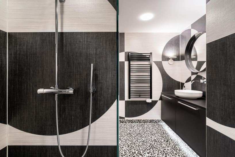 circle meets square in hotel suite interior defined by black-and-white wall compositions - 6