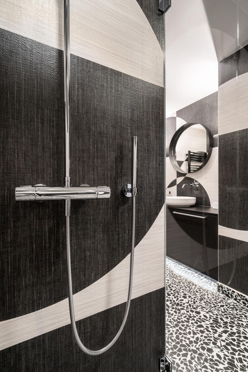 circle meets square in hotel suite interior defined by black-and-white wall compositions - 7