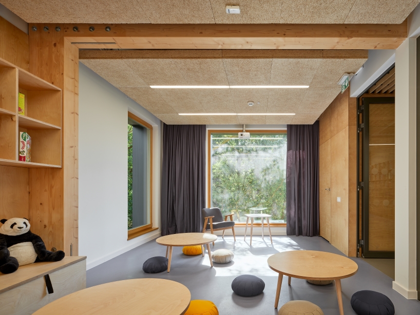 public library clad in washed timber integrates with warsaw's wooded neighborhood - 7