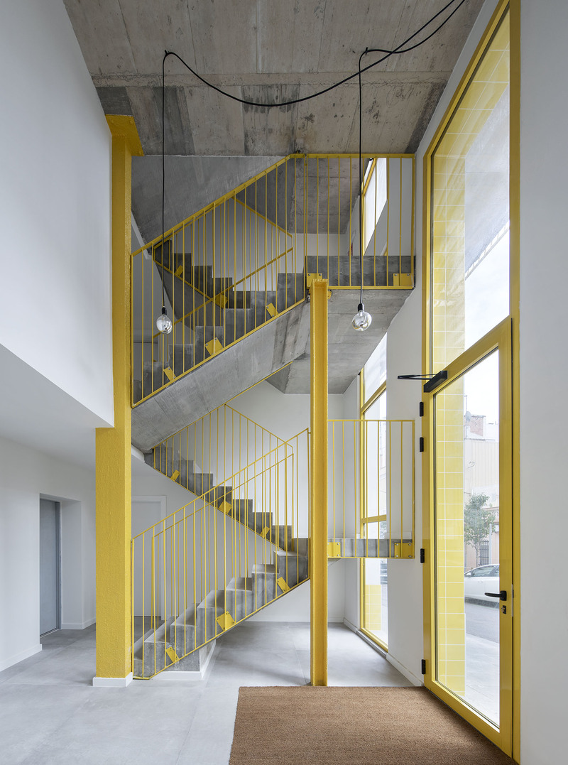 yellow steel, concrete, and circular openings revive corner building in spain as apart-hotel - 7
