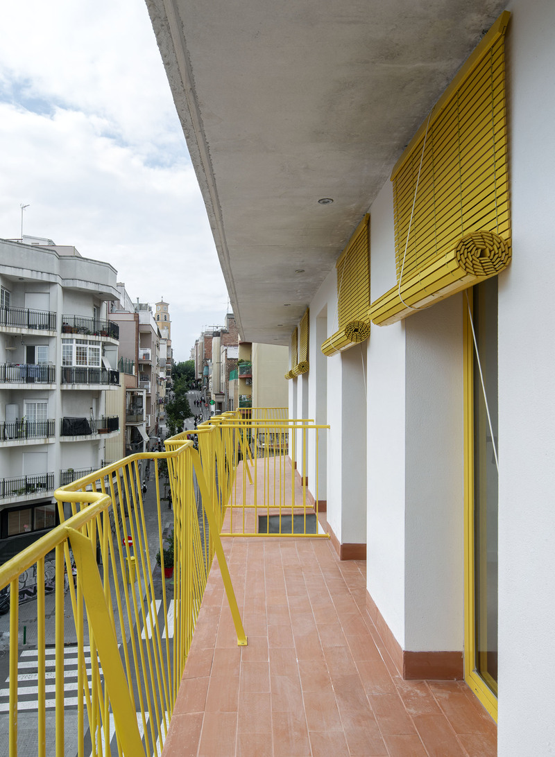 yellow steel, concrete, and circular openings revive corner building in spain as apart-hotel - 6