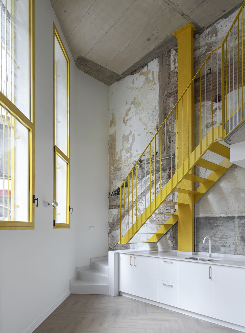 yellow steel, concrete, and circular openings revive corner building in spain as apart-hotel - 10