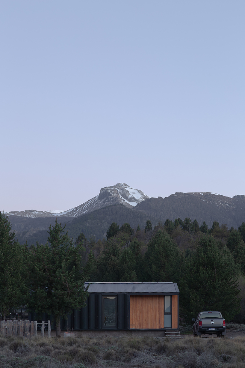 a modular cabin stands between river, forest, and mountains in argentine patagonia - 9