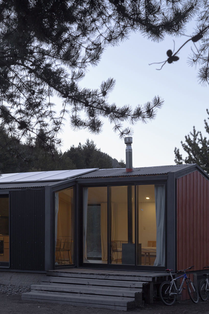 a modular cabin stands between river, forest, and mountains in argentine patagonia - 8