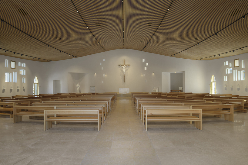 a flowing roof and fluid concrete walls frame the new santa barbara parish complex in sicily - 9